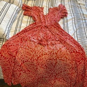 Burnt orange floral printed romper. Long tail. Size M